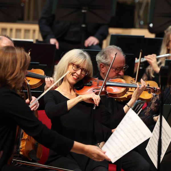 Violinists smiling on stage