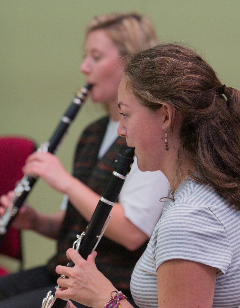 Two female musicians playing the clarinet