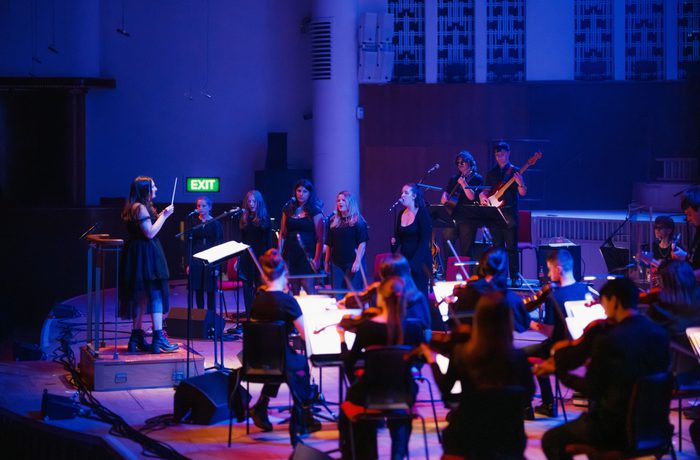 Liverpool Philharmonic Youth Session Band performing on stage at Liverpool Philharmonic Hall with blue lighting