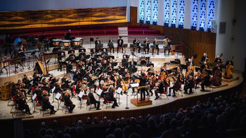 A photo of the Royal Liverpool Philharmonic Orchestra performing on stage, taken from above in the Grand Circle