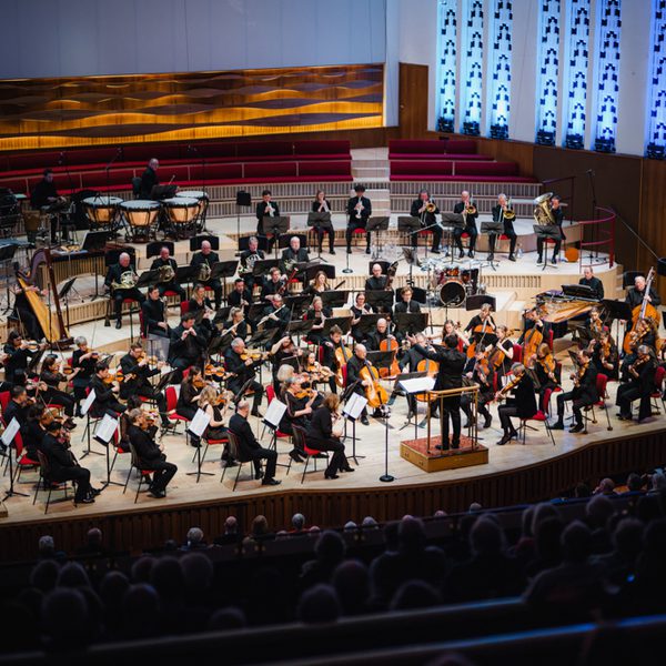 A photo of the Royal Liverpool Philharmonic Orchestra performing on stage, taken from above in the Grand Circle