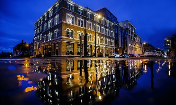 Exterior of Hope Street Hotel, also reflected in the rain on the road