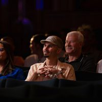 4 audience members sat down watching the stage