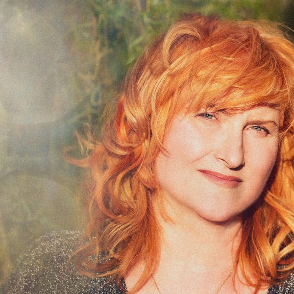 Eddi Reader who has ginger short wavy hair looking into the camera