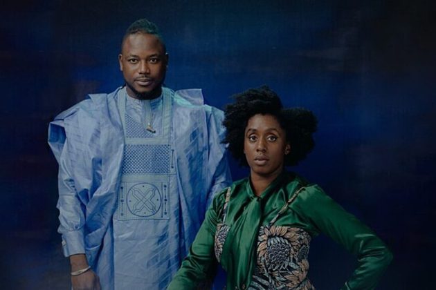 Sidiki Dembélé and lead violinist Rakhi Singh sitting in front of a blue background wearing blue patterned clothes