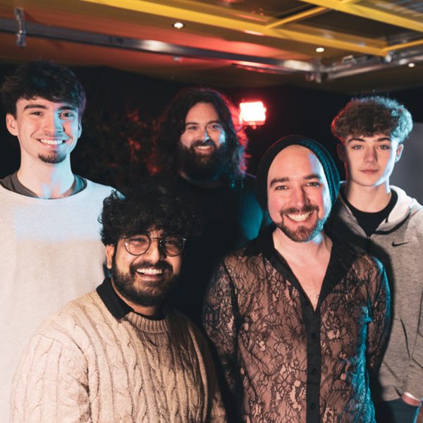Mike Ryan and the Paranoid Android band smiling at the camera