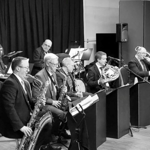 A black and white photograph of Phil Shotton and his band performing