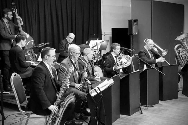 A black and white photograph of Phil Shotton and his band performing