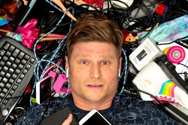 Image of Scott Bennett laying in the floor surrounded by gadgets