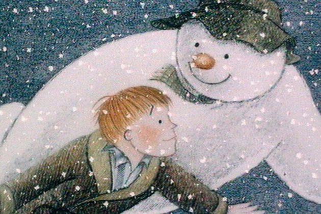 Cartoon drawing of a snowman wearing a green hat, flying through the sky with a young ginger boy wearing a green dressing gown