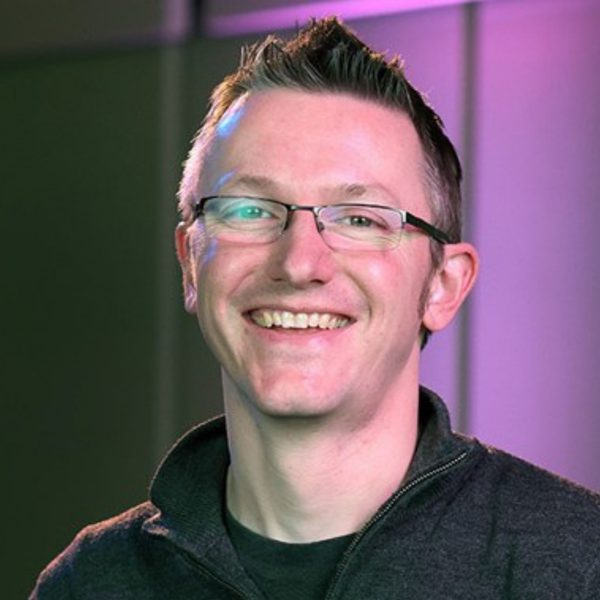 Ian Fair, a white man with short grey hair and square glasses, wearing a grey jumper