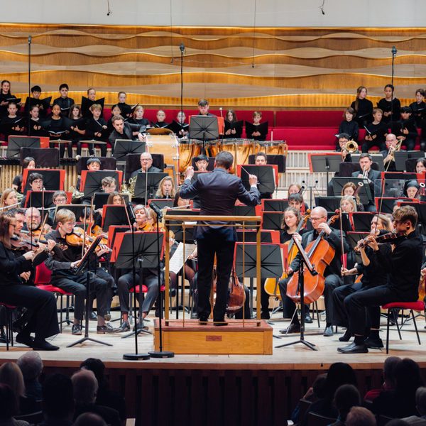 Members of Youth Orchestra performing on stage dressed in all black