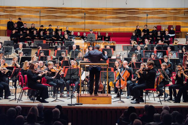 Members of Youth Orchestra performing on stage dressed in all black