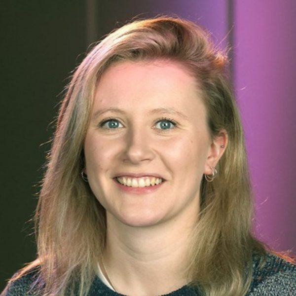 Emma Burgess, a white woman with shoulder length blonde hair, smiling at the camera