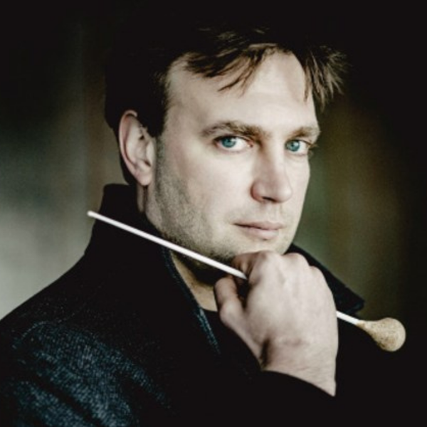 Karel Deseure, a white man with short brown hair, holding a baton and leaning on his hand