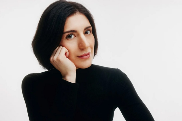 Mariam Batsashvilli, a white woman with short black hair, wearing a black turtleneck leaning on her right hand