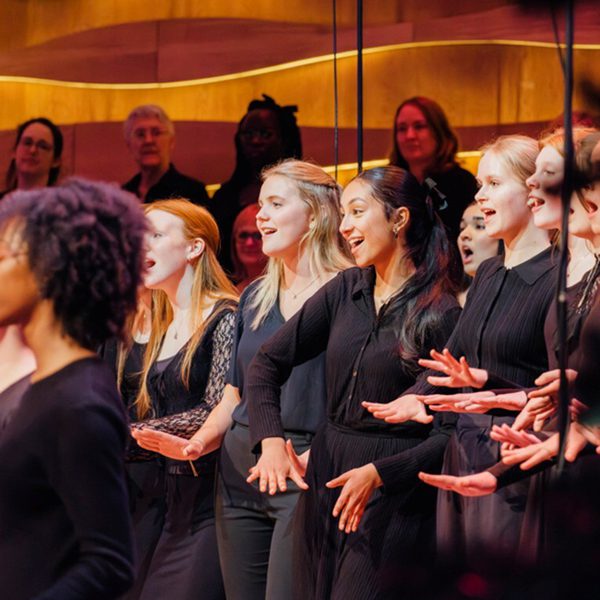 Members of the Liverpool Philharmonic Youth Choir stood in a row smiling and singing