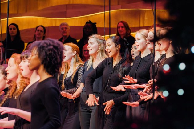 Members of the Liverpool Philharmonic Youth Choir stood in a row smiling and singing